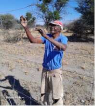 Rakops farmer installing the fence