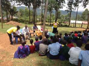 Gladys demonstrating how to use the menstrual pads