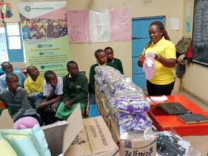 Maureen demonstrating to the girls how to use pads