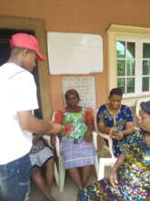 Our Project Leader giving money to the widows