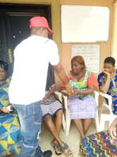 Our Project Leader giving money to the widows
