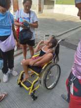 Samantha Assisted by her Dad using wheelchair