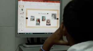 Student using PowerPoint to create a presentation