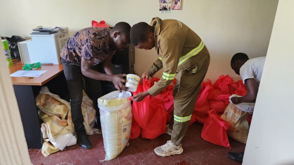 Staff and Volunteer Packing Rice to Give Families