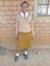 Angela Poses for a photo outside Lawsons School