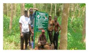 Workers in front of our "Trees for Peace" sign