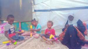 Displaced embroiderer and her children, Gaza