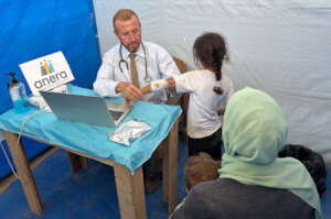 A girl receives medical care at an Anera clinic