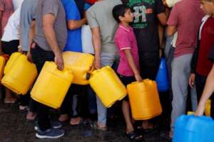 Palestinians gather to collect water