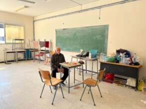 Displaced man living in a Plan supported shelter