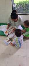 Adoptee reading to foster children