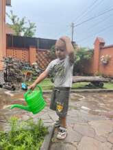Child watering garden