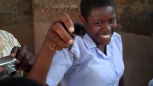 Girls happily display their chicken