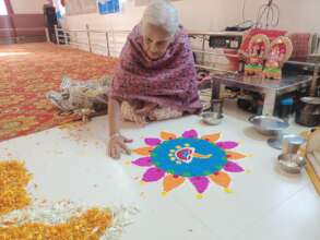 Elderly mother Doing art decorations for Diwali