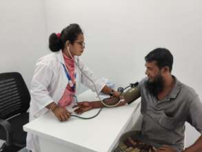 Jannatul checking blood pressure of a patient