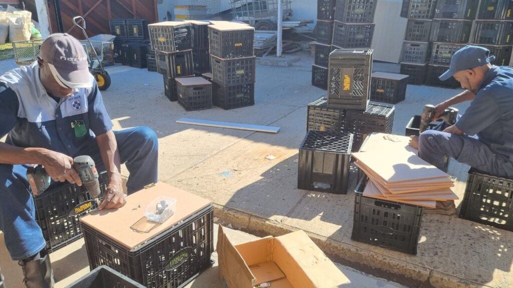 Staff hard at work fitting lids to 'cat carriers'