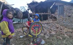 EQ affected house and bicycle of children