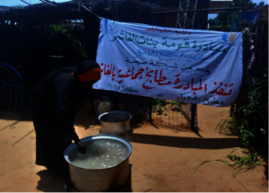 A woman from the Gomat Banat Al Fasher cooking