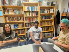 FM staff help Delando set up new laptop laptop