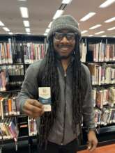 FM member Anthony holding library card