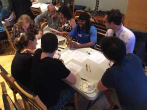 Charles talks to volunteers at the May Write Night
