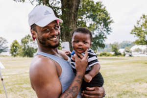 Brandon with his son at our summer BBQ