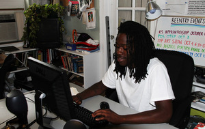Member Kwame works on his resume in the office