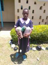 A sponsored child with their seeds