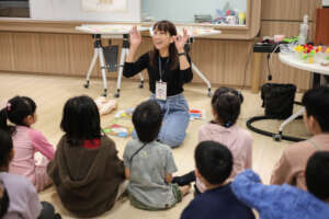 Teacher guiding circle activity with kids