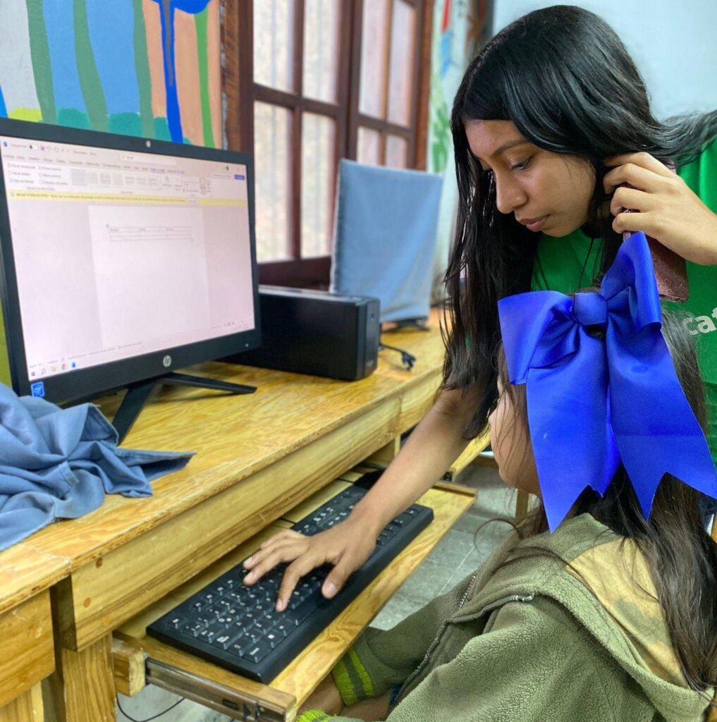 A youth leader guiding a student in a class