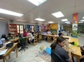 Los y las jovenes desarrollando taller de robotica