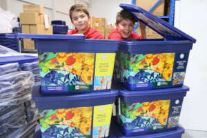 Two excited students with our newly branded kits