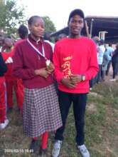Another win, showing her trophy with teacher