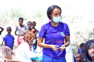 A mobile health team tends to community members
