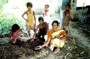 Manavi member demonstrating vermi-compost