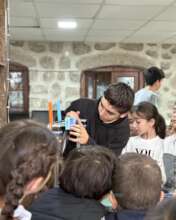 Jirair showing the 3D printer to students