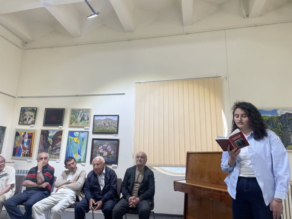 Student reading a poem at the literary event