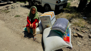 Caption: Child receiving a food package.