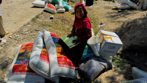 Caption: Child receiving a food package.