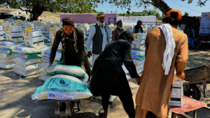 Caption: People taking the food packages home.