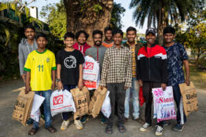 Some boys returning from purchasing new clothes.