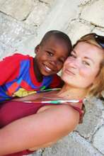 An EDV Volutneer Gives on of the Kids a Cuddle