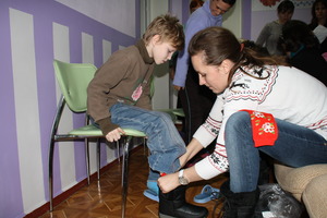A boy is fitted with new boots