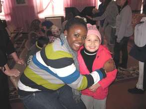 Mission volunteer dotes on little girl