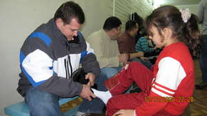 CERI Volunteers Fit Boots to Children's Feet
