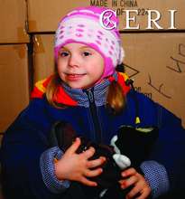Little girl holding new pair of boots