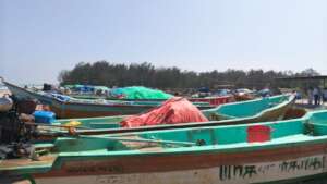 The scrotching hot sun where fishermen mend nets