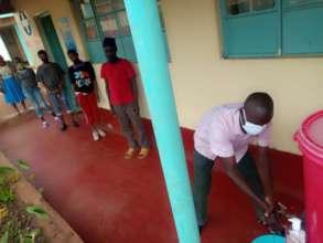 Children line up to wash their hands