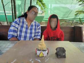 A child and therapist with clay work