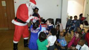Santa giving present to children